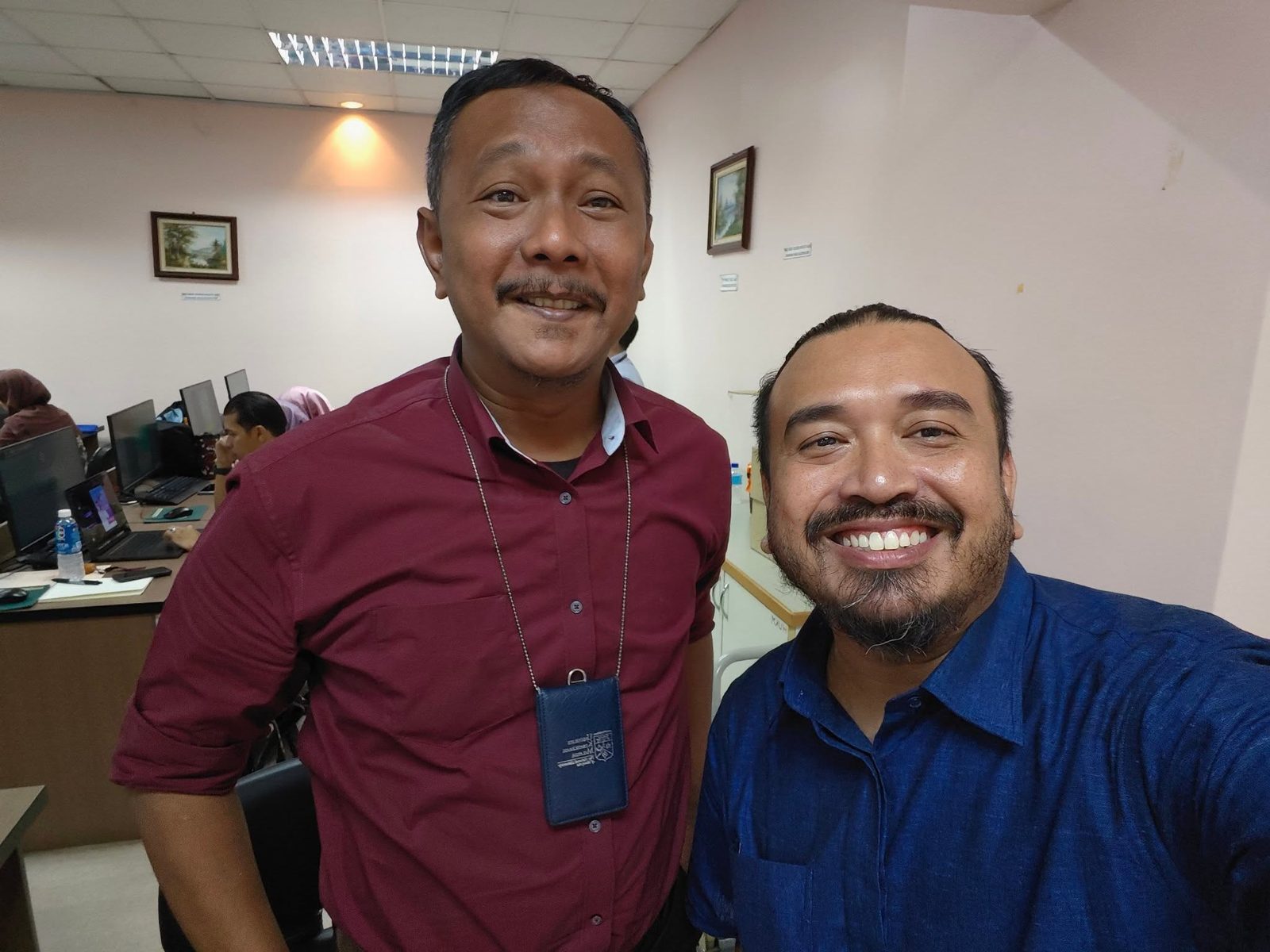 Norzaful taking a selfie with a staff member in the computer lab
