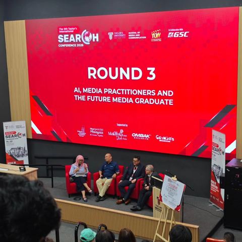 Panel discussion on stage under a Round 3 slide